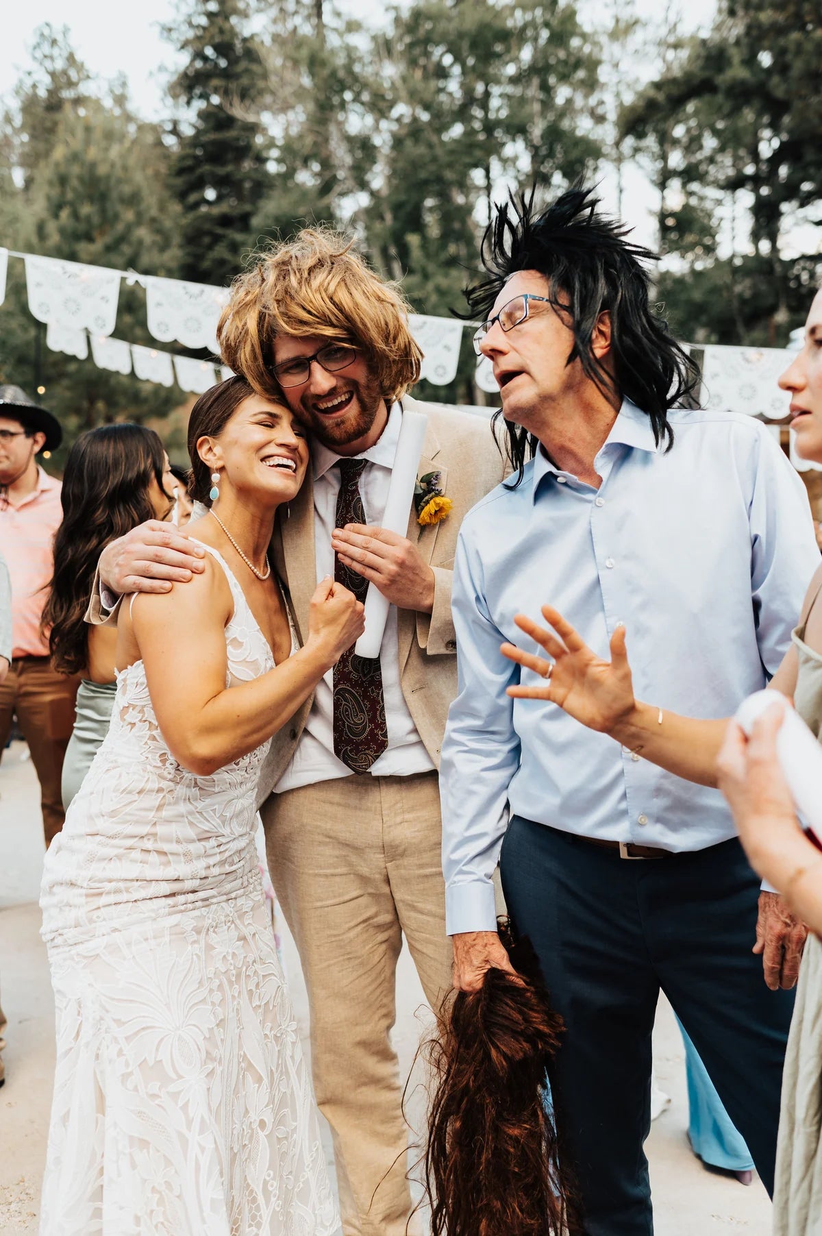 Bride laughing into a wigged groom