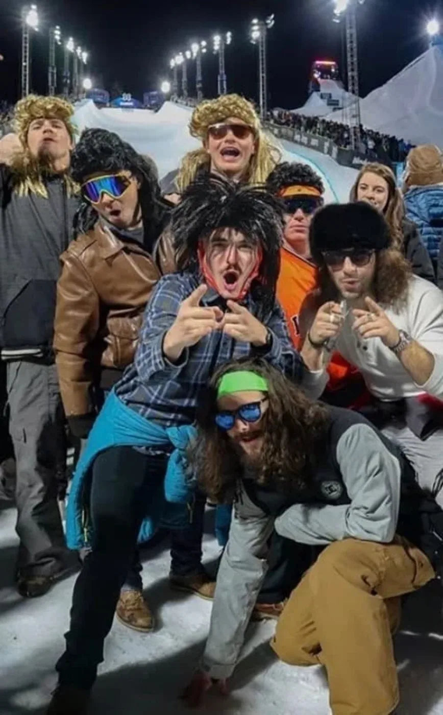 A dim party crowd in mullets